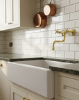 Kitchen with white sink, tiled wall, and wooden pots.