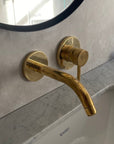 Unlacquered brass single handle wall mounted faucet